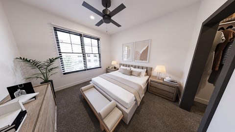 A bedroom with a large bed, a ceiling fan, and a window with blinds.
