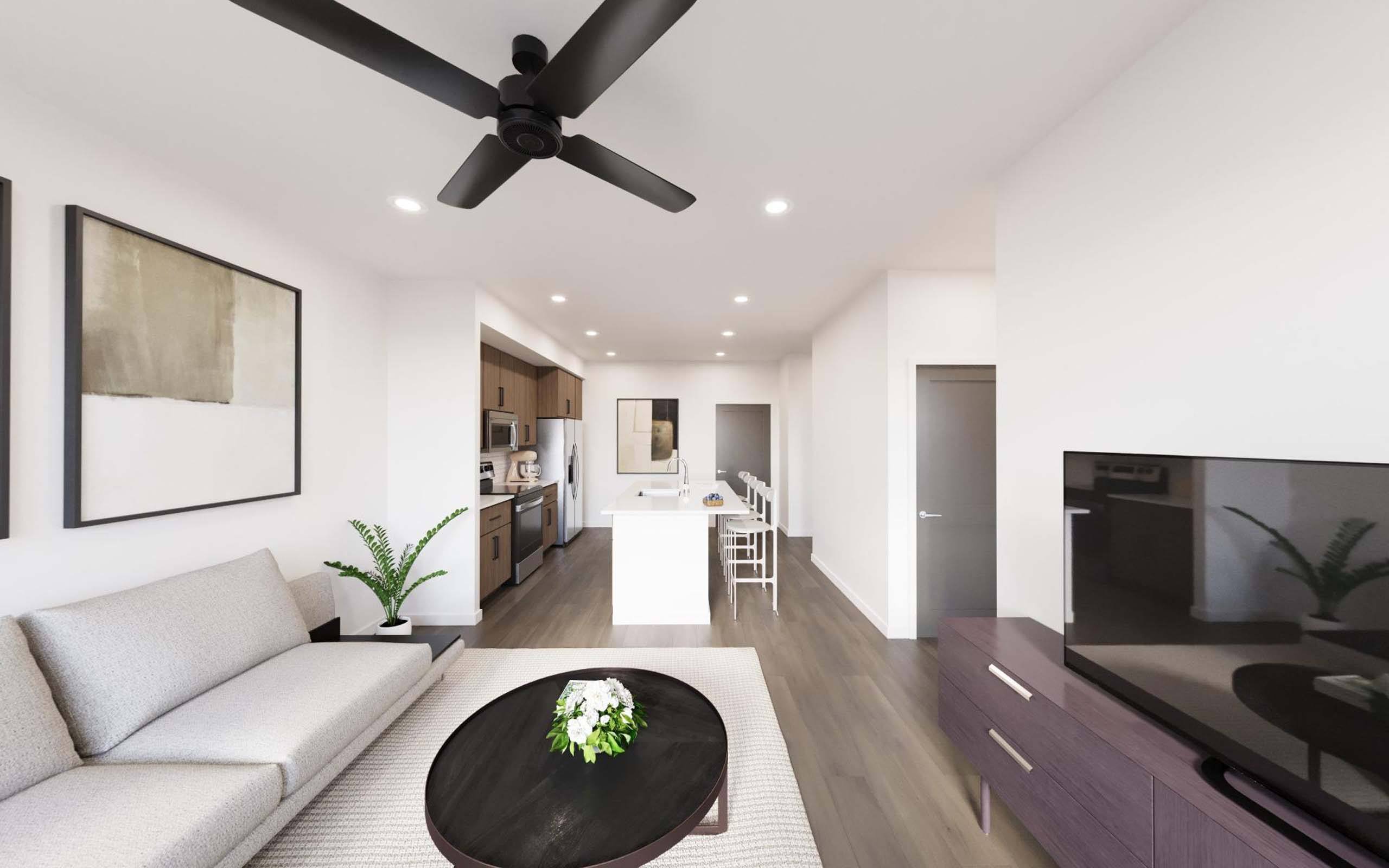 A modern living room with a white sofa and a black coffee table.