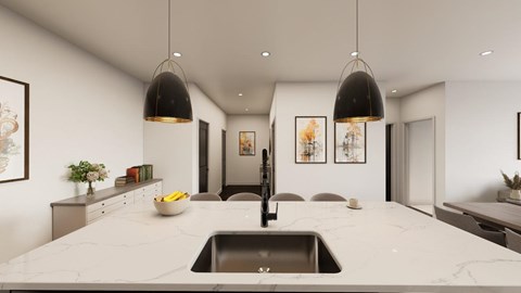 A modern kitchen with a marble countertop and pendant lights.