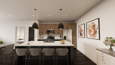 A modern kitchen with a large island and chairs.