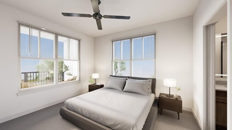 A bedroom with a large bed and a ceiling fan.