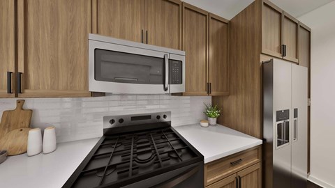 A modern kitchen with wooden cabinets and a black stove top.