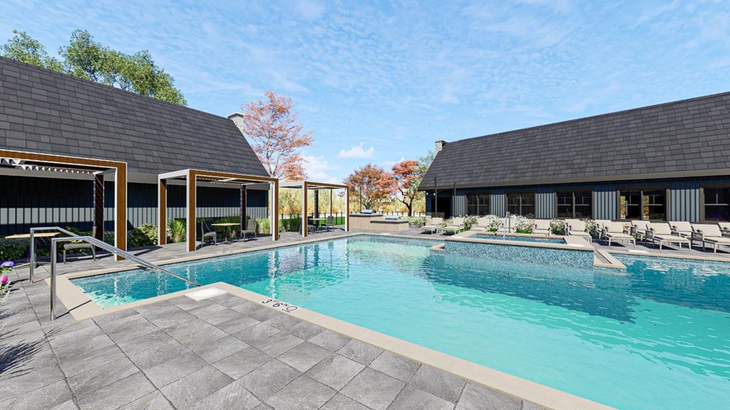 A large outdoor swimming pool surrounded by lounge chairs and umbrellas.at The Landing at Lemay, Fort Collins