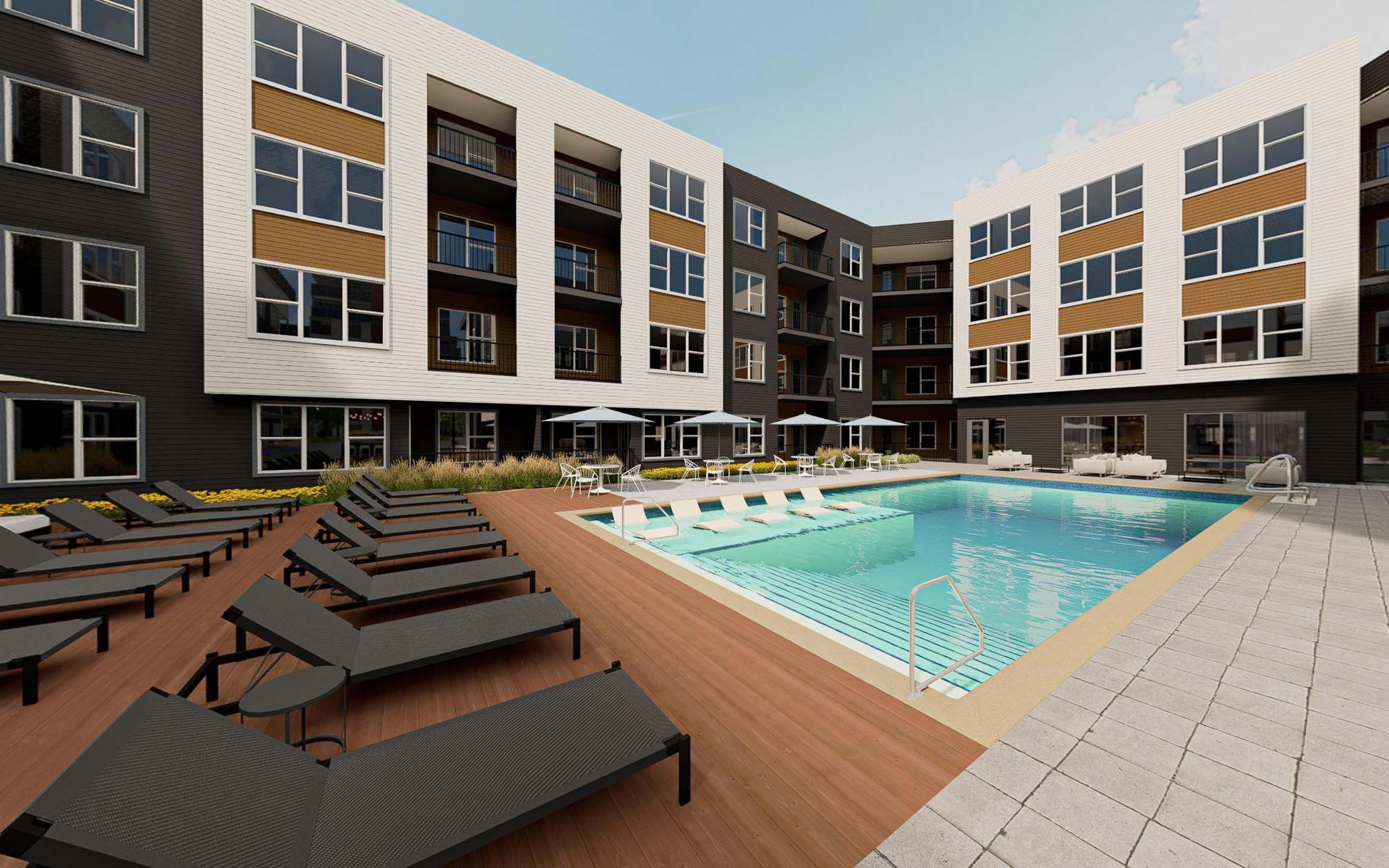 A large swimming pool with lounge chairs in front of apartment buildings.