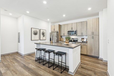 A kitchen with a bar stool in front of the counter. at The Junction at Rockledge Apartments, Florida, 32955