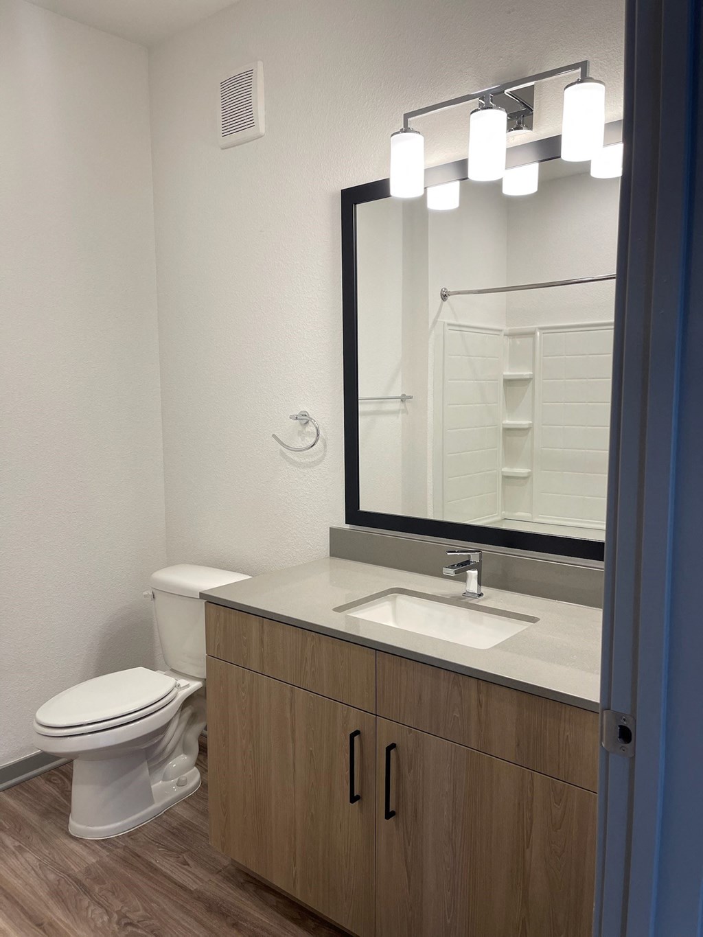 a bathroom with a toilet and a sink and a mirror