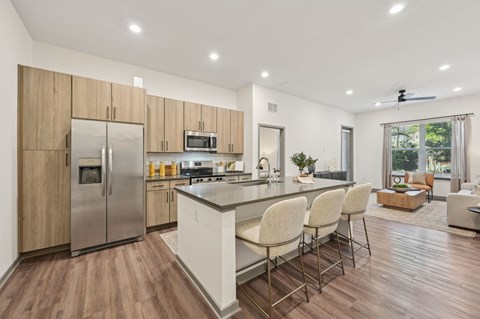 A modern kitchen with wooden cabinets and a white island.