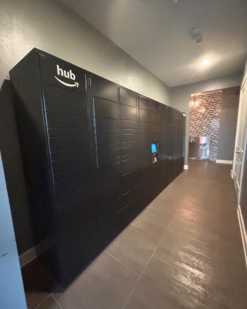 a long hallway with black lockers and a tv on the wall  at Watermark at Steele Crossing, Arkansas, 72703
