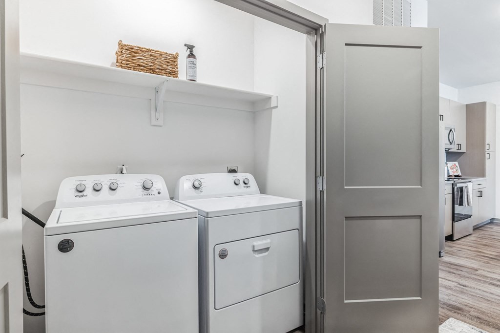 a small laundry room with a washer and dryer and a shelf above the washer  at Prism at Diamond Ridge, Pennsylvania, 15108