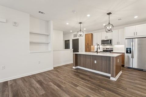A kitchen with a wooden island and stainless steel appliances. at The Junction at Rockledge Apartments, Florida