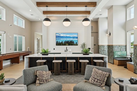 A modern kitchen with a large island and bar stools. at The Junction at Rockledge Apartments, Florida, 32955