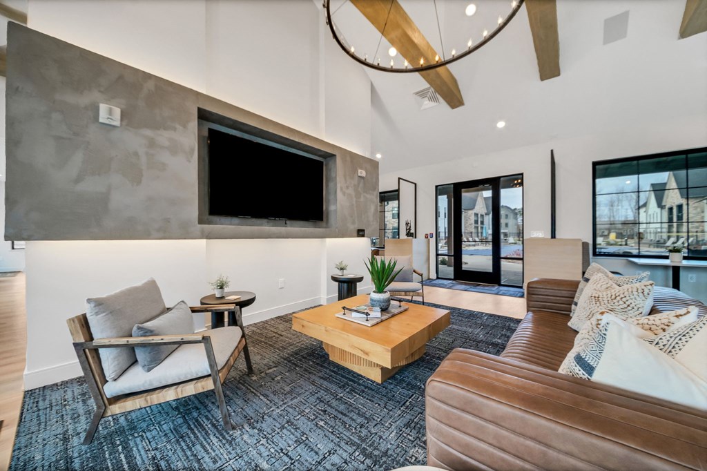 a living room with couches and a tv at The BLVD at Wilson Crossings, Wyoming Michigan