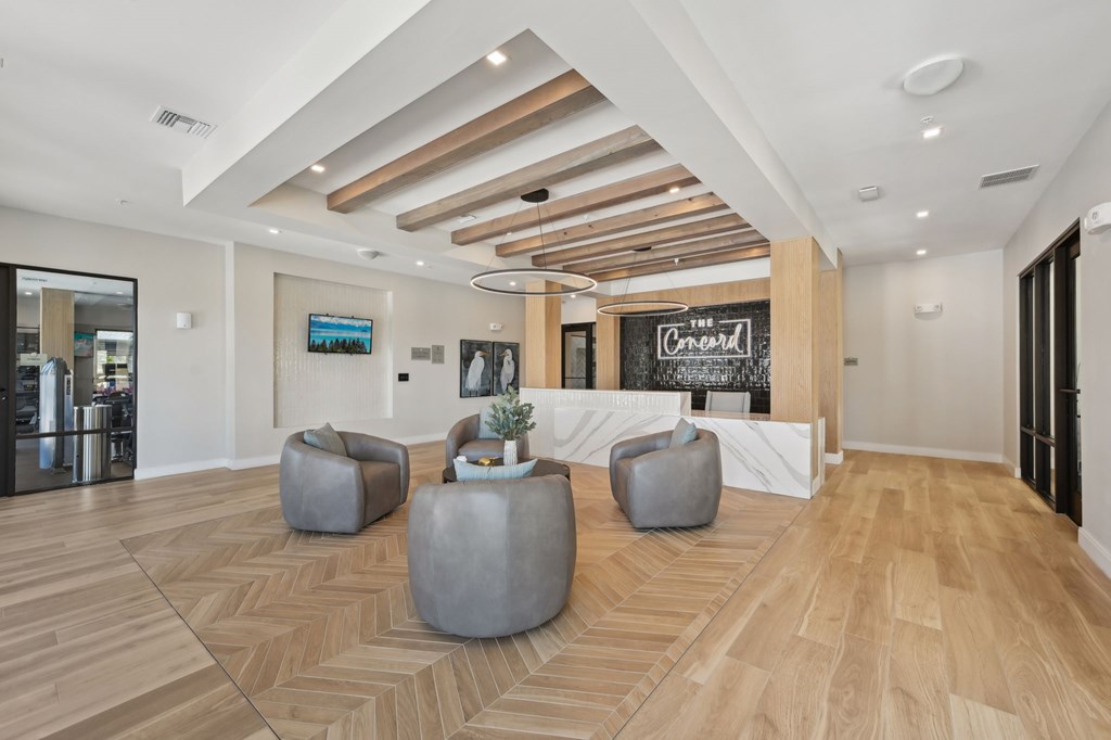 A room with a wooden floor and a white counter with a chalkboard on it at The Concord Luxury Apartments, Florida