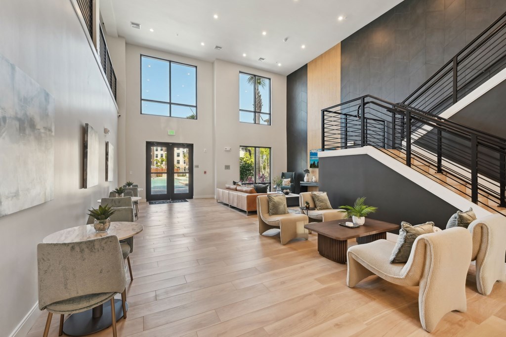 A spacious living room with a staircase on the right side at The Concord Luxury Apartments, Sarasota