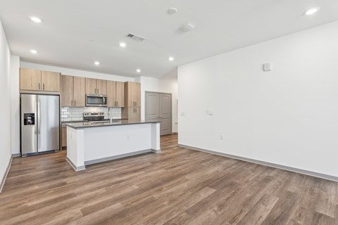 A kitchen with wooden floors and white walls. at The Junction at Rockledge Apartments, Rockledge 32955