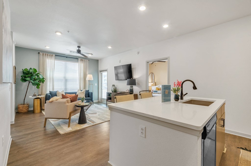 a kitchen and living room with white walls and hardwood flooring at Apex, Colorado Springs, Colorado