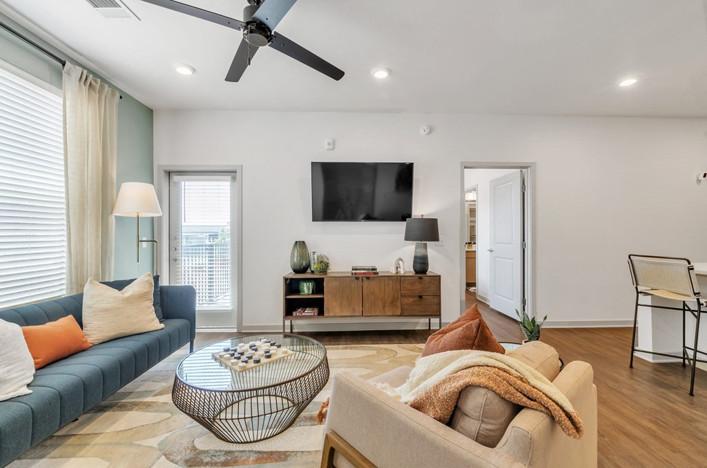 a living room with a blue couch and a tv on the wall at Apex, Colorado, 80923