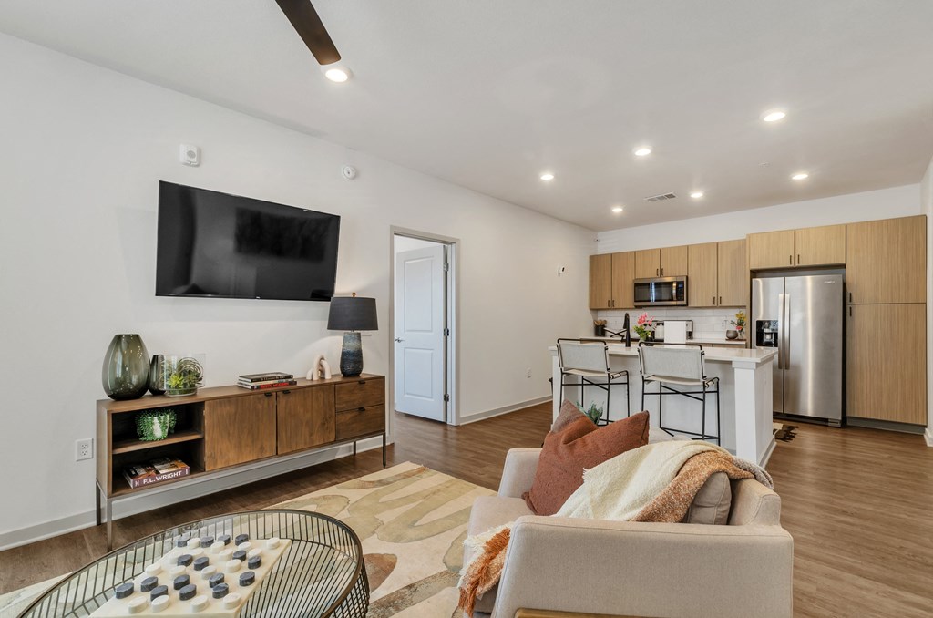 a living room and kitchen area with a large tv on the wall at Apex, Colorado Springs, Colorado