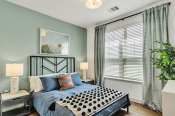 a bedroom with a bed and two night stands with lamps at Apex, Colorado, 80923