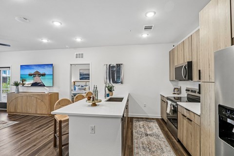 A modern kitchen with wooden cabinets and a white island.