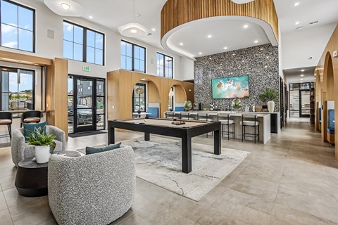 A spacious lobby with a reception desk and a large painting on the wall.
