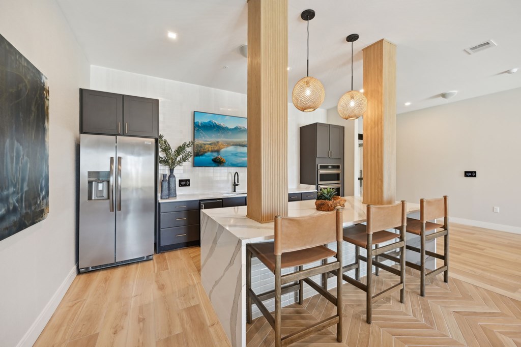 A modern kitchen with a dining table and chairs at The Concord Luxury Apartments, Sarasota, FL