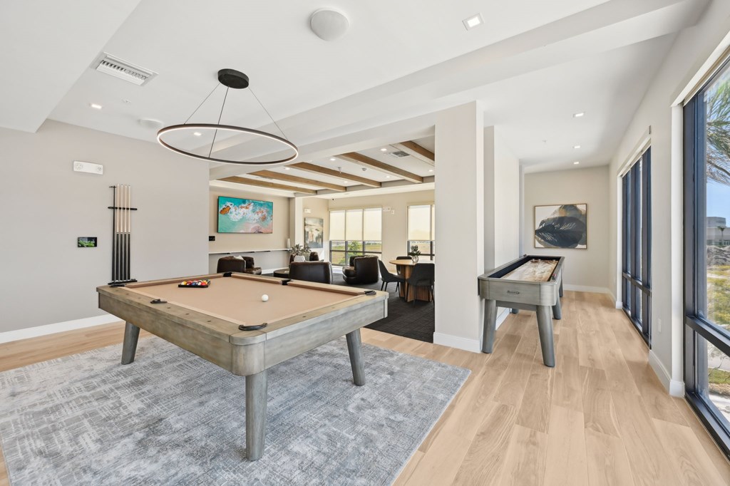 A pool table is in the middle of a room with a billiard table at The Concord Luxury Apartments, Sarasota, Florida