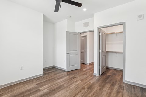 A room with a ceiling fan and two open doors. at The Junction at Rockledge Apartments, Rockledge, Florida