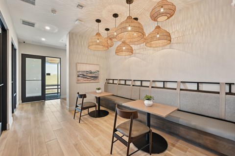 A modern dining area with a long table and chairs.