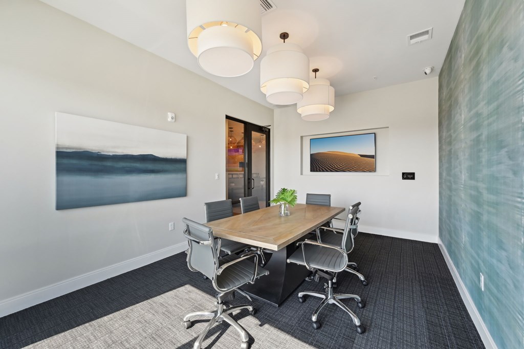 A conference room with a long table and chairs at The Concord Luxury Apartments, Florida