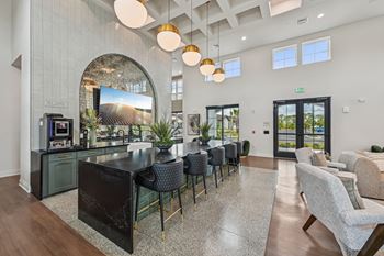 A modern kitchen with a black countertop and a large island. at The Hadley - North Port, FL Apartments, North Port