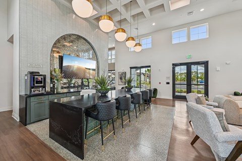 A modern kitchen with a black countertop and a large island at The Hadley - North Port, FL Apartments, Florida, 34287