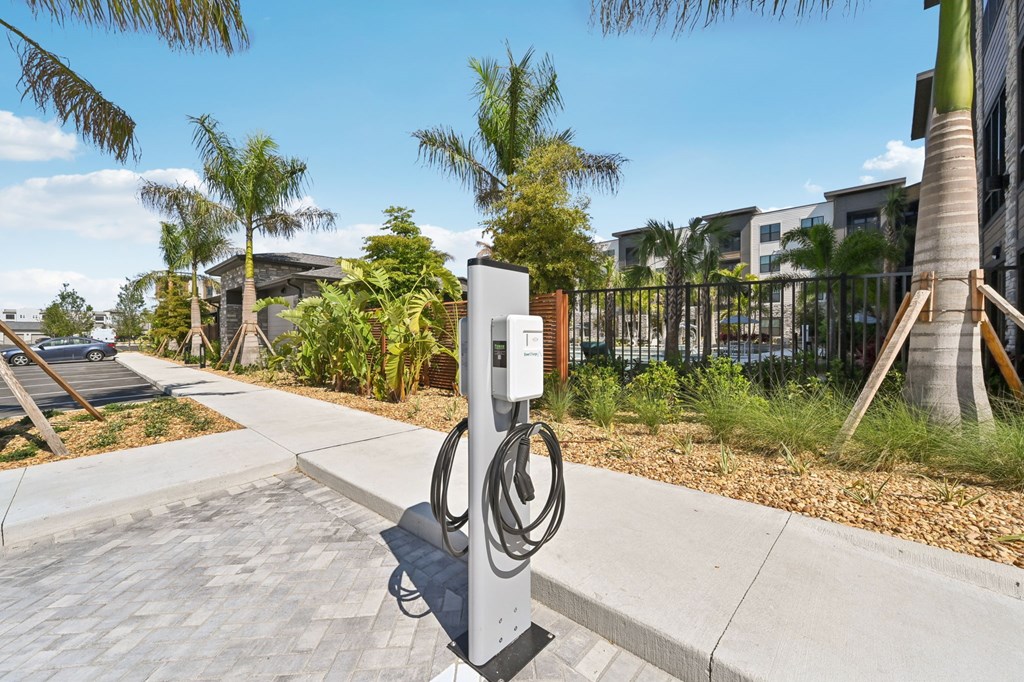 A charging station for electric vehicles is located on a sidewalk at The Concord Luxury Apartments, Sarasota, FL, 34240