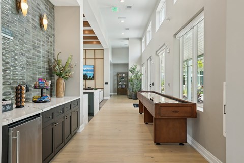 A long hallway with a counter on the left and a door at the end. at The Junction at Rockledge Apartments, Rockledge