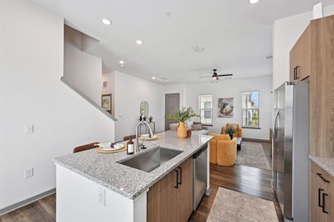 A modern kitchen with a granite countertop and stainless steel appliances. at The Hadley - North Port, FL Apartments, North Port