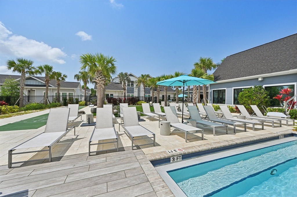 A pool with a 3 feet depth sign and chairs around it. at The Sophia, Venice, FL, 34275