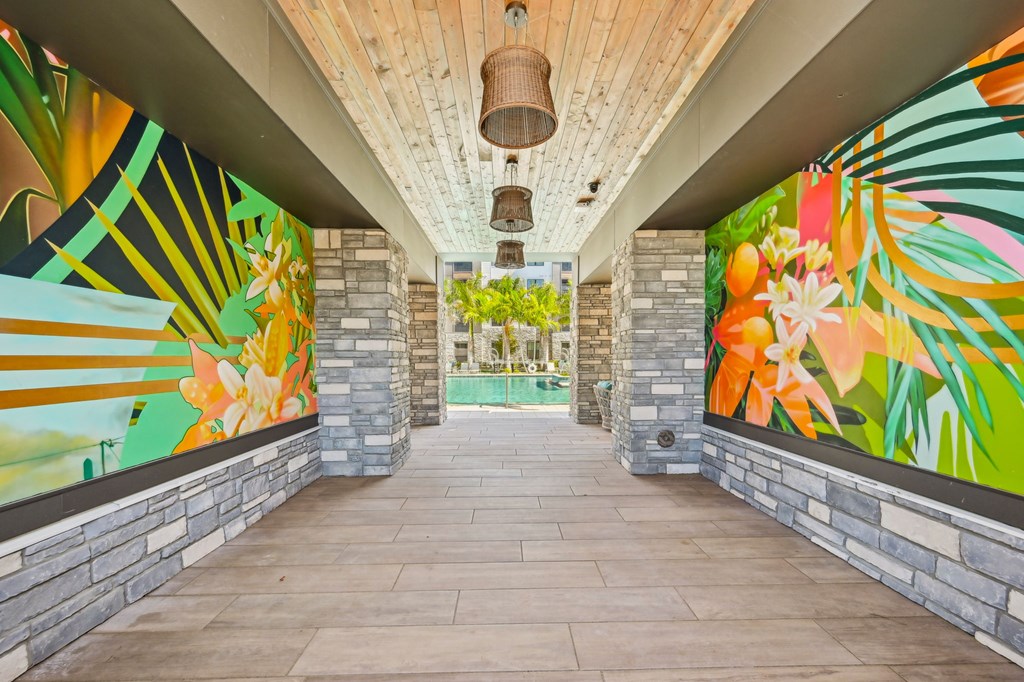 A long hallway with a mural on the wall at The Concord Luxury Apartments, Sarasota 34240