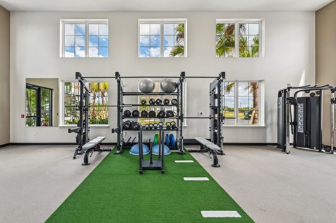 A gym with a green mat in the middle of the room at The Hadley - North Port, FL Apartments, North Port, FL