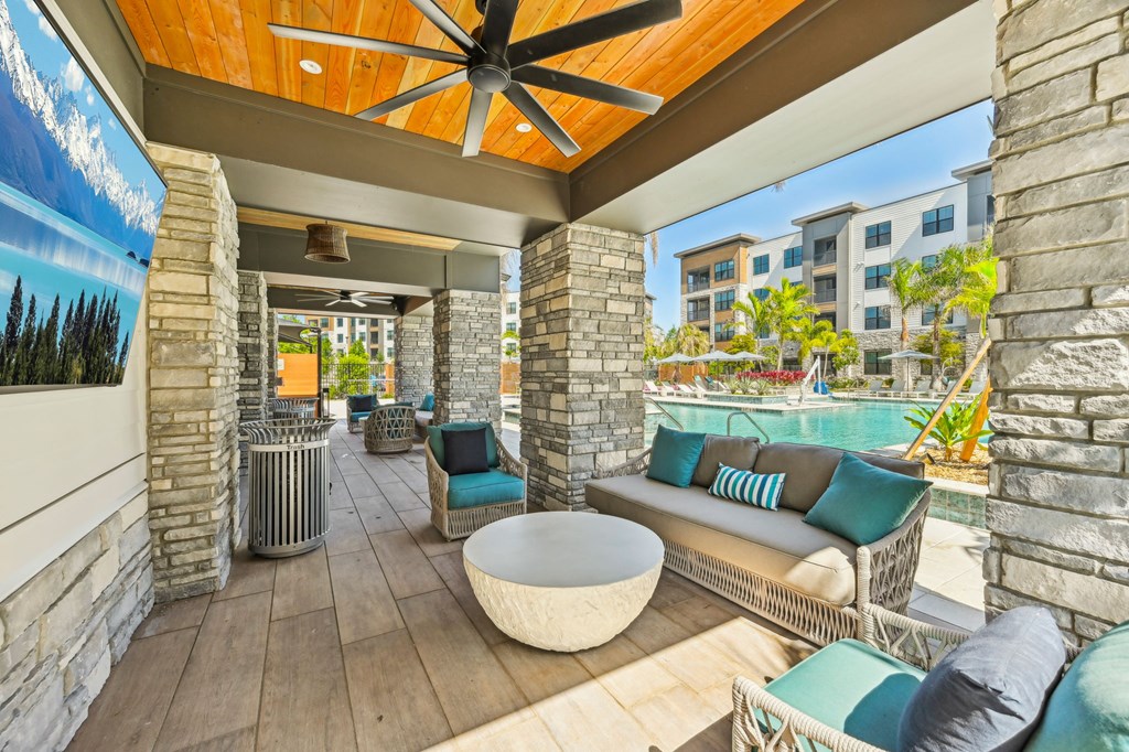 A patio with a white table and blue cushions at The Concord Luxury Apartments, Sarasota, FL, 34240