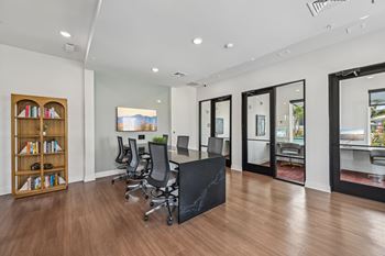 A room with a black table and chairs with a view of the outside at The Hadley - North Port, FL Apartments, Florida, 34287