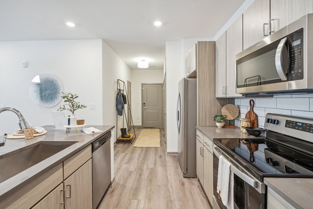 a kitchen in a 555 waverly unit with stainless steel appliances  at Taylor Farms, Charlotte, NC, 28262