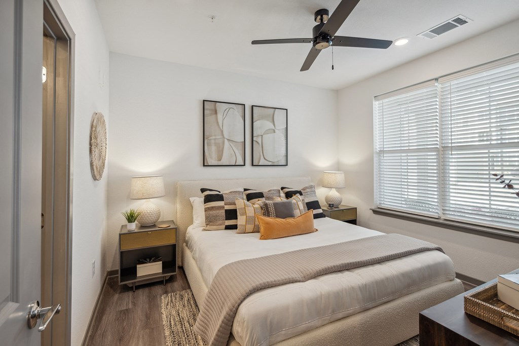 a bedroom with a ceiling fan and a large window  at Taylor Farms, North Carolina