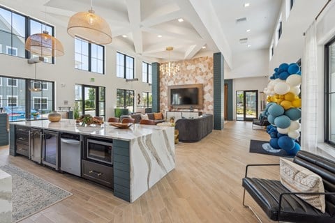 a kitchen with a large center island next to a living room with a couch and a fireplace  at Taylor Farms, Charlotte