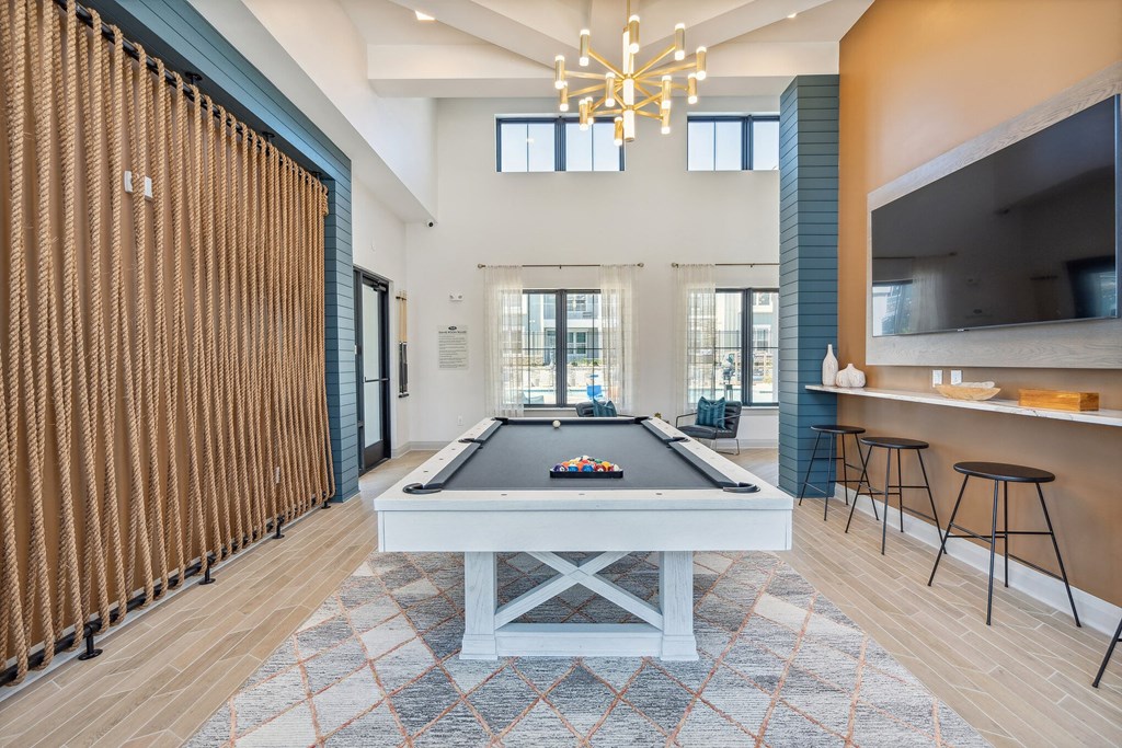 a pool table in the clubhouse at the bradley braddock road station apartments  at Taylor Farms, Charlotte