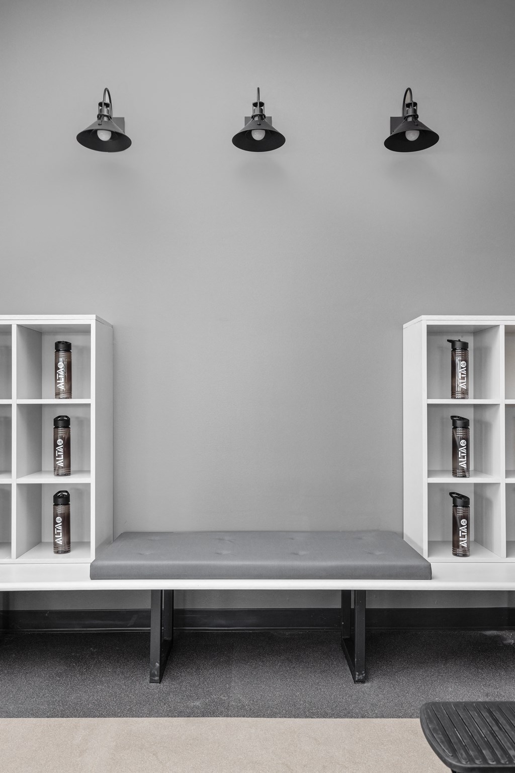 a bench in a room with two black lights on the wall and two white shelves at Alta25, Colorado, 80132