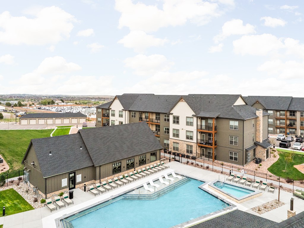 an aerial view of an apartment building with a swimming pool