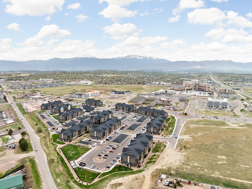 an aerial view of a city with houses and a highway