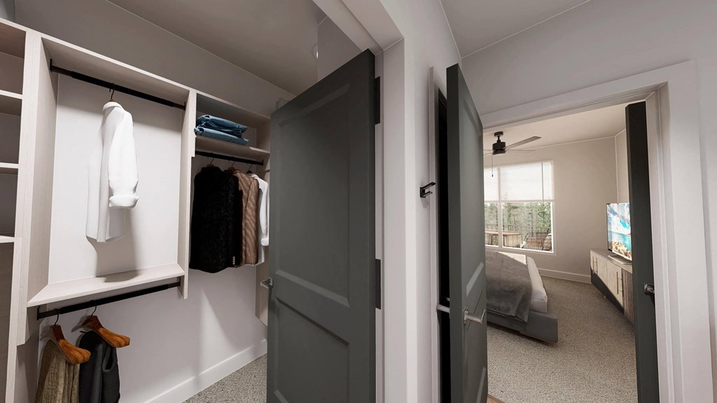 a walk in closet with a door open to a bedroom