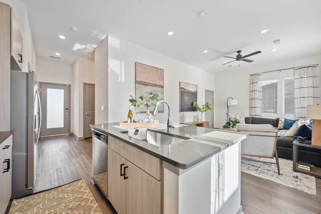 a kitchen with a large island and a living room at Citadel at Castle Pines, Castle Pines, 80108