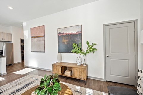 a living room with white walls and a table with a plant at Citadel at Castle Pines, Castle Pines, CO, 80108